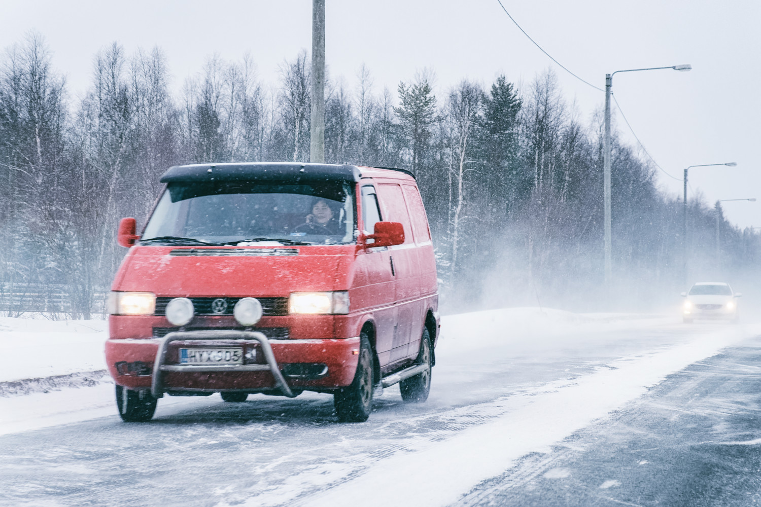 Mini van at the Snowy Winter Road Finland Lapland EU