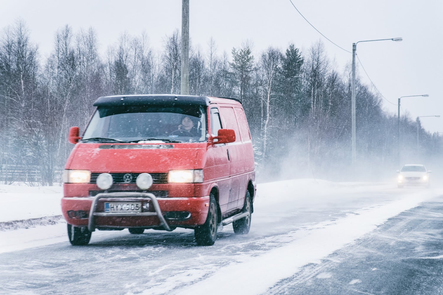 Mini van at the Snowy Winter Road Finland Lapland EU